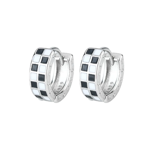 Detail showing checkered enamel pattern and star engravings on silver hoop earrings