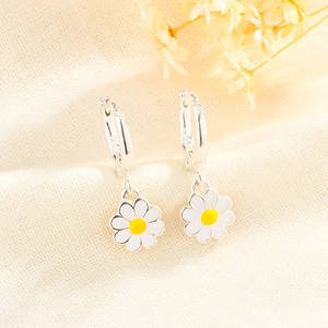 Close-up of S925 sterling silver stamp on small white daisy floral hoop earrings