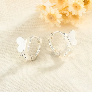 Close-up of S925 sterling silver butterfly hoop earrings with polished metal finish