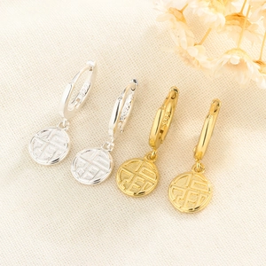 Macro detail of gold and silver S925 sterling silver earrings with Chinese Fu character