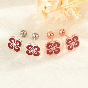 Macro detail of red enamel flower earrings with classical cloud patterns and screw backs
