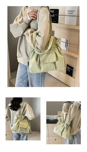 Detail of light green corduroy drawstring bucket bag with flap pocket and texture
