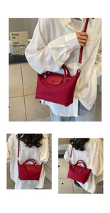 Detail of red oxford nylon dumpling bag with leather flap and golden metal hardware