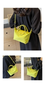 Detail view of lime green nylon dumpling bag with leather flap and detachable strap