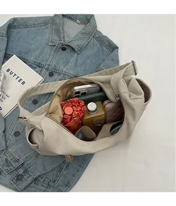 Interior detail of large canvas crossbody bag showing spacious storage for daily items