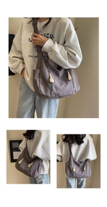 Detail view of large grey canvas crossbody bag with twin vertical zipper pockets