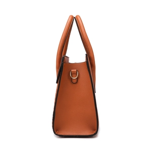 Side view of orange brown leather tote bag with dual handles and gold metal D-rings