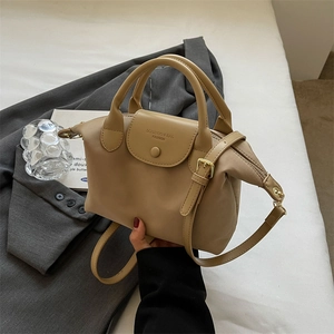 Fashionable beige oxford fabric dumpling bag with contrast stitching and top handle strap