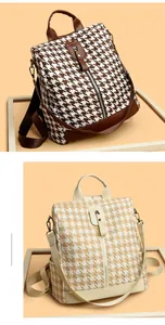 Detail of houndstooth backpack showing spaghetti straps and premium leather stitching