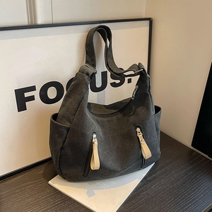 Black canvas hobo bag with multi-zipper pockets and contrast leather pull tabs