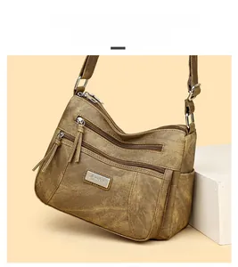 Macro detail of trapezoid retro brown textured leather bag with multi-pocket zipper design