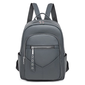 Detailed view of grey lychee texture PU leather backpack with front zipper and side pockets