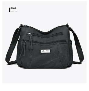 Detail view of the black crossbody bag showing waterproof nylon texture and zip pockets