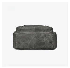 Detailed bottom view of soft grey washed denim crossbody bag with reinforced stitching