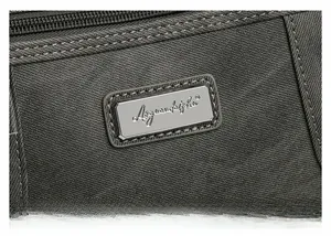 Detail of durable twill fabric and rectangular metal logo plate on dark grey crossbody bag