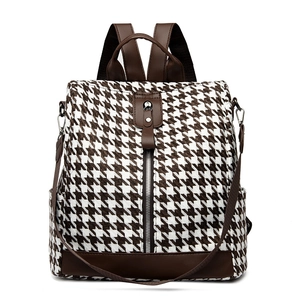Fashionable houndstooth backpack with brown leather trim and versatile straps