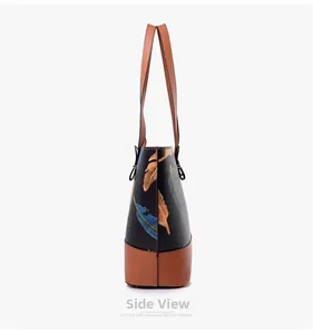 Side view of faux leather tote bag with colorful feather prints and brown contrast base