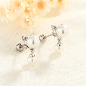 Cute silver cat ear studs with white freshwater pearls and screw back closures
