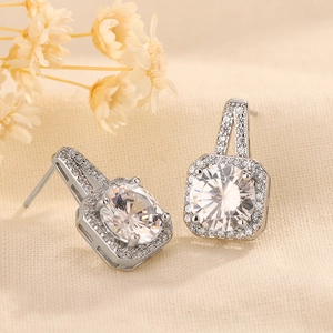 Macro shot of silver drop earrings with halo-set round brilliant cut cubic zirconia