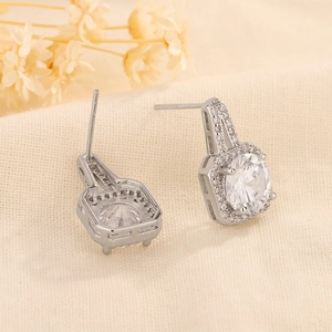 Macro shot of silver square stud earrings with central round zircon and S925 stamp