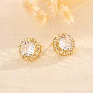 Detail of round halo stud earrings featuring micro-pave diamonds and large center zircon