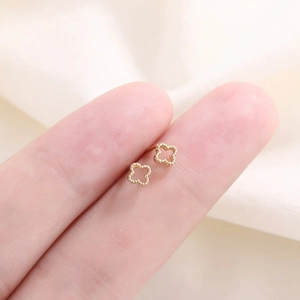 Puces d'oreilles trèfle évidées en or avec texture perlée délicate et élégante