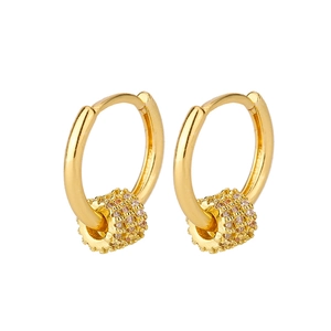 Detail of gold circular hoop earrings featuring crystal-paved cylindrical bead charms