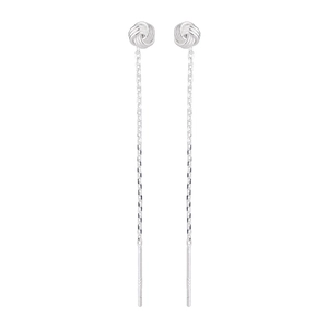 Macro shot of silver tassel earrings featuring traditional woven knots and long chain drops