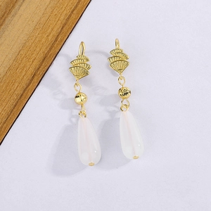 Detail of vintage gold fan-shaped earrings with milky white teardrop chalcedony pendants