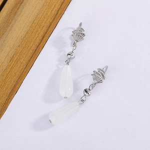 Macro detail of Chinese style silver fan earrings with white chalcedony teardrop pendants