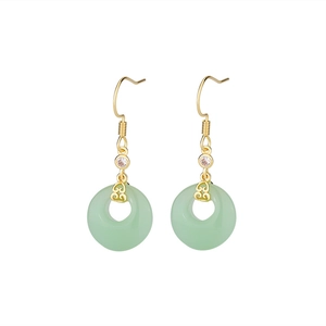 Detail of Chinese style earrings with gold cloud motifs and green jade-like pendants