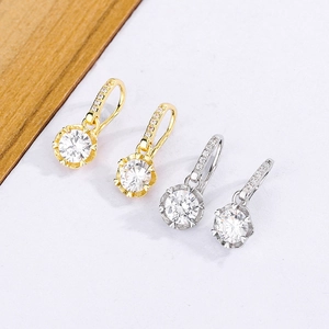 Close-up of lever-back earrings with large round-cut zircons in gold and silver finish