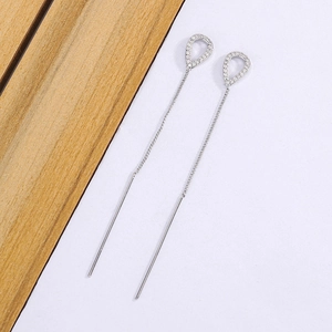 Detail view of long tassel drop earrings in silver with shimmering zircon stones