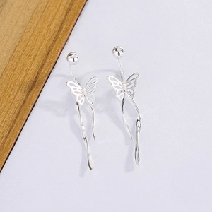 Detailed view of elegant silver ribbon butterfly earrings with long wavy tassel chains