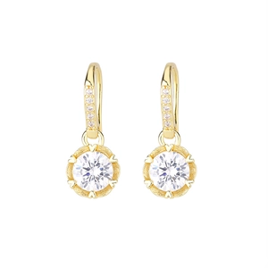 Detail of gold dangle earrings with a large round cubic zirconia and heart-shaped prongs