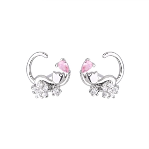 Macro detail of cat stud earrings featuring pink teardrop zircon and silver finish