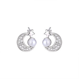 Detail of star and moon stud earrings with white pearls and sparkling pavé crystals