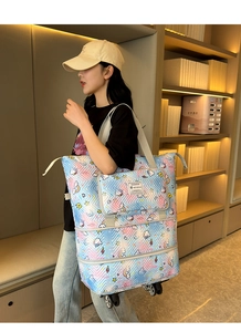 Detail of expandable gradient travel bag with wheels and cartoon unicorn patterns
