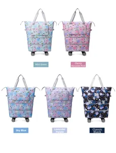Detail view of foldable travel bags in five colors with swivel wheels and cartoon prints