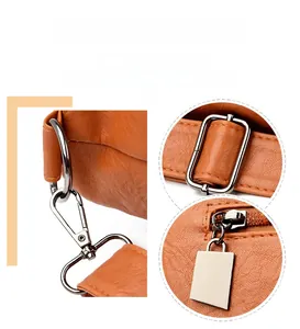 Detail of glossy hardware and textured orange lychee faux leather on tote bag