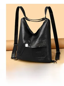 Detail of black pebbled leather backpack with rivet flap and silver zipper pockets
