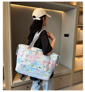 Detail of the expandable travel tote with rainbow unicorn print and built-in wheels