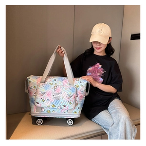 Detail of quilted travel tote featuring rainbow prints and built-in wheels for easy rolling