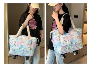 Detail view of large travel tote with wheels featuring colorful unicorn and rainbow patterns
