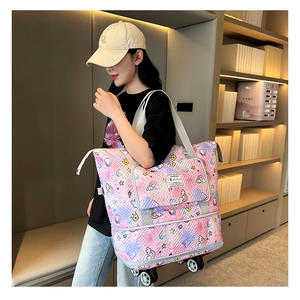 Detail of pink cartoon travel bag with swivel wheels and quilted V-texture pattern