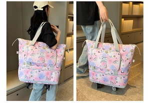 Detail of the expandable layer and rolling wheels on the cartoon print travel tote bag