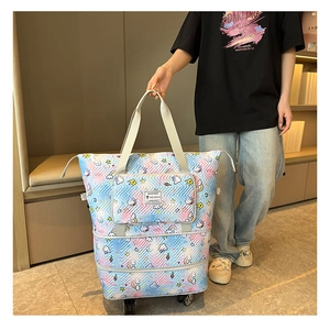 Detail of expandable tie-dye travel bag with wheels and unicorn print on nylon fabric