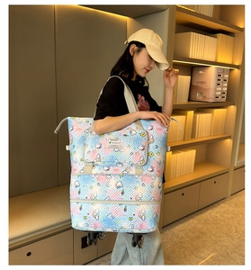 Close-up of large travel tote with unicorn print, swivel wheels, and adjustable layers
