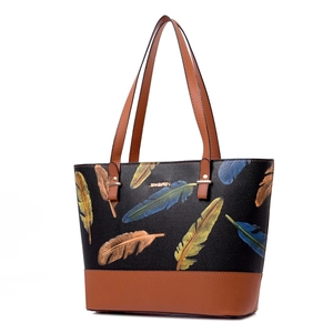 Women's tote bag with feather print and brown leather stitching on white background