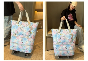 Detail of quilted travel tote with 360-degree wheels and cartoon cloud pattern